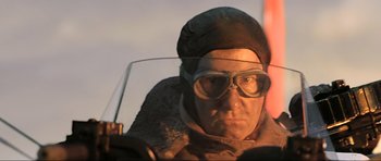 Movie still from “King Kong” (2005), directed by Peter Jackson – An older man wearing glasses and wearing a hat; Close Up shot, Low angle