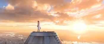 Movie still from “King Kong” (2005), directed by Peter Jackson – A woman standing on top of a building looking out at the sky; Extreme Wide shot, Low angle