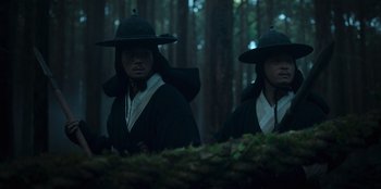 Movie still from “Kingdom: Ashin of the North” (2021), directed by Kim Seong-hun – Two men in traditional korean garb in the woods; Medium shot, Low angle