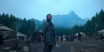 Movie still from “Kingdom: Ashin of the North” (2021), directed by Kim Seong-hun – A man standing in the middle of a field; Wide shot, Low angle