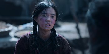 Movie still from “Kingdom: Ashin of the North” (2021), directed by Kim Seong-hun – A young girl with pigtails is looking at the camera; Close Up shot, Low angle