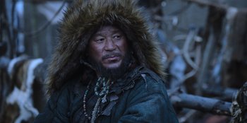 Movie still from “Kingdom: Ashin of the North” (2021), directed by Kim Seong-hun – A man with a beard wearing a fur coat; Close Up shot, Low angle