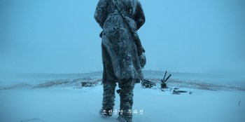 Movie still from “Kingdom: Ashin of the North” (2021), directed by Kim Seong-hun – A man in a fur coat standing in the snow; Wide shot, Low angle
