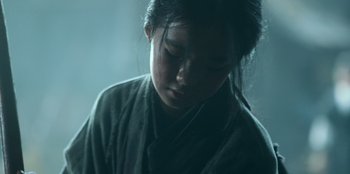 Movie still from “Kingdom: Ashin of the North” (2021), directed by Kim Seong-hun – A young girl is looking down at her face; Close Up shot, Low angle