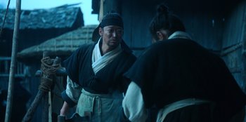 Movie still from “Kingdom: Ashin of the North” (2021), directed by Kim Seong-hun – A man and a woman in traditional japanese garb; Medium shot, Low angle