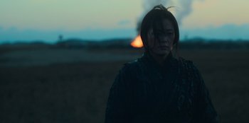 Movie still from “Kingdom: Ashin of the North” (2021), directed by Kim Seong-hun – A woman standing in the middle of an open field at night; Medium shot, Over the shoulder angle