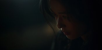 Movie still from “Kingdom: Ashin of the North” (2021), directed by Kim Seong-hun – A woman's face in the dark; Close Up shot, Low angle