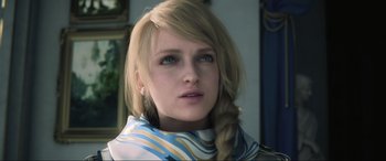 Movie still from “Kingsglaive: Final Fantasy XV” (2016), directed by Takeshi Nozue – A woman with blonde hair wearing a blue and white scarf; Close Up shot, Over the shoulder angle