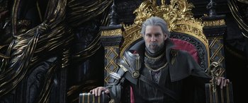 Movie still from “Kingsglaive: Final Fantasy XV” (2016), directed by Takeshi Nozue – A man with grey hair is sitting on a throne; Close Up shot, Over the shoulder angle