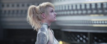Movie still from “Kingsglaive: Final Fantasy XV” (2016), directed by Takeshi Nozue – A woman with blonde hair is wearing a silver outfit; Close Up shot, Low angle