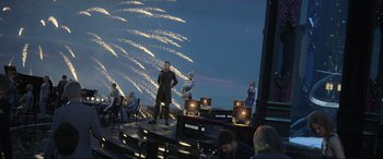Movie still from “Kingsglaive: Final Fantasy XV” (2016), directed by Takeshi Nozue – A group of people standing on a stage with fireworks in the background; Extreme Wide shot, Over the shoulder angle