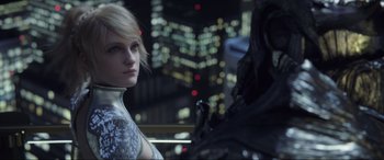 Movie still from “Kingsglaive: Final Fantasy XV” (2016), directed by Takeshi Nozue – A woman standing next to a man in a city; Close Up shot, Over the shoulder angle