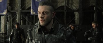Movie still from “Kingsglaive: Final Fantasy XV” (2016), directed by Takeshi Nozue – A person wearing a leather jacket; Close Up shot, Over the shoulder angle