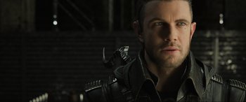 Movie still from “Kingsglaive: Final Fantasy XV” (2016), directed by Takeshi Nozue – A person with a lizard on his shoulder; Close Up shot, Over the shoulder angle