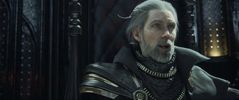Movie still from “Kingsglaive: Final Fantasy XV” (2016), directed by Takeshi Nozue – An old man with a beard and a long gray beard; Close Up shot, Over the shoulder angle