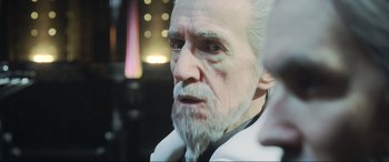Movie still from “Kingsglaive: Final Fantasy XV” (2016), directed by Takeshi Nozue – An old man with white hair and a white beard looking at the camera; Close Up shot, Over the shoulder angle