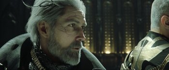 Movie still from “Kingsglaive: Final Fantasy XV” (2016), directed by Takeshi Nozue – An old man with a long gray beard; Close Up shot, Low angle