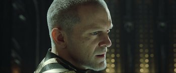 Movie still from “Kingsglaive: Final Fantasy XV” (2016), directed by Takeshi Nozue – A person with a bald head; Close Up shot, Low angle