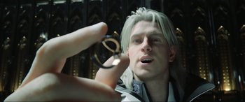 Movie still from “Kingsglaive: Final Fantasy XV” (2016), directed by Takeshi Nozue – A man holding a pair of glasses up to his face; Close Up shot, Over the shoulder angle