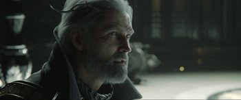 Movie still from “Kingsglaive: Final Fantasy XV” (2016), directed by Takeshi Nozue – An old man with a beard and a white beard; Close Up shot, Over the shoulder angle