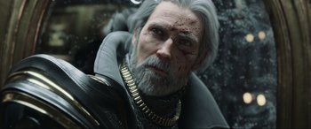 Movie still from “Kingsglaive: Final Fantasy XV” (2016), directed by Takeshi Nozue – An old man with a beard and a white beard; Close Up shot, Low angle