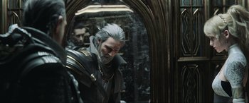 Movie still from “Kingsglaive: Final Fantasy XV” (2016), directed by Takeshi Nozue – A man with a long gray beard standing in front of a mirror; Close Up shot, Over the shoulder angle