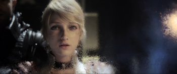 Movie still from “Kingsglaive: Final Fantasy XV” (2016), directed by Takeshi Nozue – A woman with blonde hair looking out of a window; Close Up shot, Over the shoulder angle