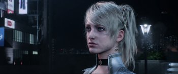 Movie still from “Kingsglaive: Final Fantasy XV” (2016), directed by Takeshi Nozue – A woman with a long blonde hair and a black collar; Close Up shot, Over the shoulder angle