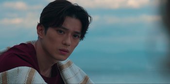 Movie still from “Knights of the Zodiac” (2023), directed by Tomasz Baginski – A person with a towel around his neck; Close Up shot, Over the shoulder angle