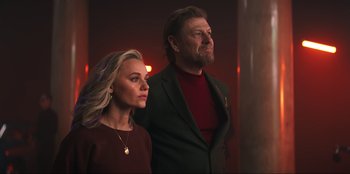 Movie still from “Knights of the Zodiac” (2023), directed by Tomasz Baginski – A man and a woman standing next to each other; Medium shot, Low angle