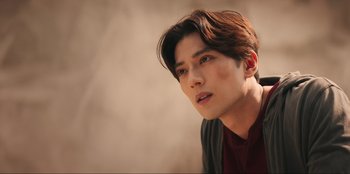 Movie still from “Knights of the Zodiac” (2023), directed by Tomasz Baginski – A person wearing a red shirt; Close Up shot, Low angle