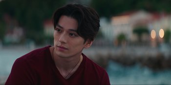 Movie still from “Knights of the Zodiac” (2023), directed by Tomasz Baginski – A person wearing a red shirt; Close Up shot, Over the shoulder angle