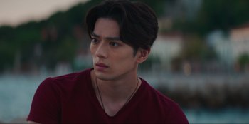 Movie still from “Knights of the Zodiac” (2023), directed by Tomasz Baginski – A person wearing a red shirt; Close Up shot, Low angle