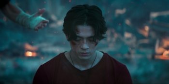 Movie still from “Knights of the Zodiac” (2023), directed by Tomasz Baginski – A young man with blood all over his face; Close Up shot, Over the shoulder angle