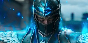 Movie still from “Knights of the Zodiac” (2023), directed by Tomasz Baginski – A man in a blue suit with a helmet on his head; Close Up shot, Low angle