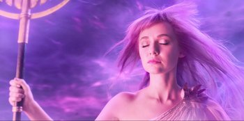 Movie still from “Knights of the Zodiac” (2023), directed by Tomasz Baginski – A woman with purple hair is posing for a picture; Close Up shot, Low angle