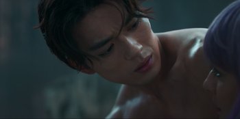 Movie still from “Knights of the Zodiac” (2023), directed by Tomasz Baginski – A man's face and his hair; Close Up shot, Low angle