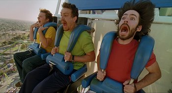 Movie still from “Knocked Up” (2007), directed by Judd Apatow – A group of men riding on a roller coaster together; Medium shot, High angle