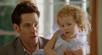 Movie still from “Knocked Up” (2007), directed by Judd Apatow – A man holding a little girl in her arms; Close Up shot, Over the shoulder angle