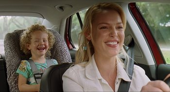 Movie still from “Knocked Up” (2007), directed by Judd Apatow – A woman and a child in the back seat of a car; Close Up shot, Over the shoulder angle