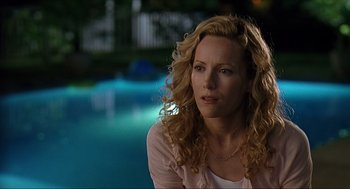 Movie still from “Knocked Up” (2007), directed by Judd Apatow – A woman sitting in front of a swimming pool at night; Close Up shot, Over the shoulder angle