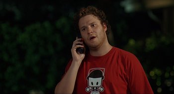 Movie still from “Knocked Up” (2007), directed by Judd Apatow – A man in red shirt talking on a cell phone; Medium shot, High angle