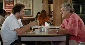 Movie still from “Knocked Up” (2007), directed by Judd Apatow – Two men are sitting at a table in a restaurant; Medium shot, Over the shoulder angle