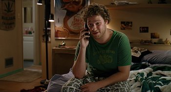Movie still from “Knocked Up” (2007), directed by Judd Apatow – A man sitting in bed talking on a cell phone; Medium shot, Overhead angle