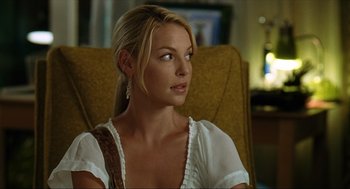 Movie still from “Knocked Up” (2007), directed by Judd Apatow – A beautiful woman sitting in a chair looking to her left; Close Up shot, Over the shoulder angle