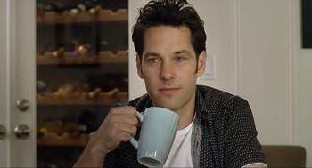 Movie still from “Knocked Up” (2007), directed by Judd Apatow – A man holding a coffee cup in his hand; Close Up shot, Over the shoulder angle