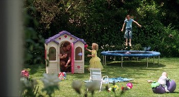 Movie still from “Knocked Up” (2007), directed by Judd Apatow – Two children playing in a little tykes house; Wide shot, High angle