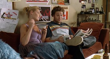 Movie still from “Knocked Up” (2007), directed by Judd Apatow – A man and a woman sitting on a couch; Medium shot, Over the shoulder angle