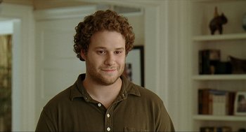 Movie still from “Knocked Up” (2007), directed by Judd Apatow – A man with curly red hair is smiling for the camera; Close Up shot, Over the shoulder angle