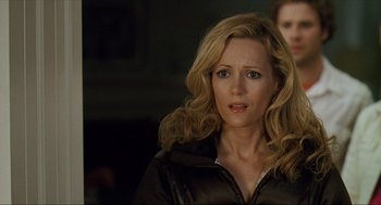 Movie still from “Knocked Up” (2007), directed by Judd Apatow – A woman with blonde curly hair wearing a black jacket; Close Up shot, Over the shoulder angle